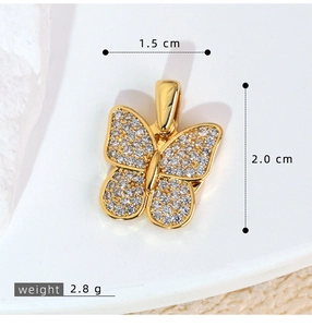 Macro shot of gold butterfly pendant with sparkling cubic zirconia pavé setting wings