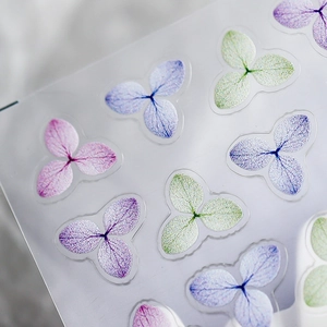 Translucent floral nail stickers featuring purple and pink hydrangea patterns for nail art