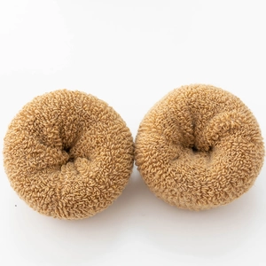 Detailed close-up of two brown textured hair ties on a clean white background