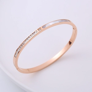 Minimalist rose gold stainless steel bangle with white shell inlay and sparkling crystals