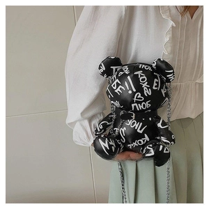 Detail of graffiti bear crossbody bag with silver chain and glossy PU leather texture