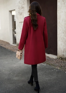 Rear view of a long red wool coat for women featuring a minimalist commute style