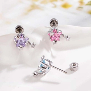 Star shaped earrings with pink, purple, and blue gemstones in a minimalist metal setting