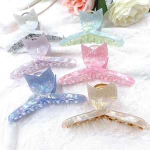 Iridescent mermaid tail hair claws in multiple colors on elegant white lace fabric