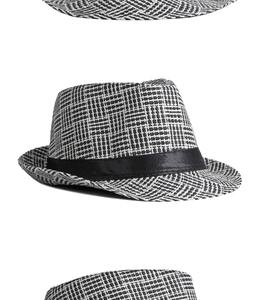 Detail of black and white checkered straw fedora with a wide black decorative ribbon