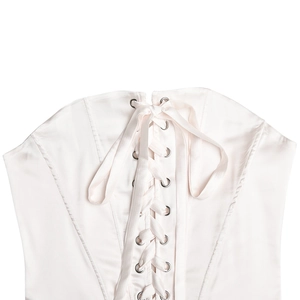 Macro view of a pink satin corset back featuring delicate ribbon lacing and metal eyelets