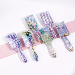 Detail of square cushion hairbrushes with glitter sequins and colorful patterns