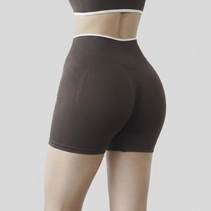 Detail of high-waist yoga shorts showing seamless scrunch butt lift and contrast white piping