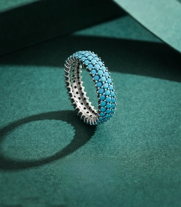 Detailed close-up of a 925 sterling silver ring featuring three rows of pavé turquoise stones