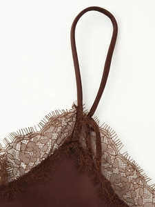 Detail of brown satin camisole featuring delicate eyelash lace trim and thin shoulder straps