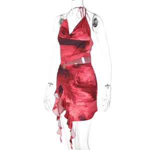 Detail of red tie-dye dress with waist cut-out and asymmetric ruffled hemline