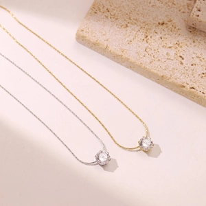 Elegant gold and silver necklaces featuring sparkling round zirconia in a four-claw setting