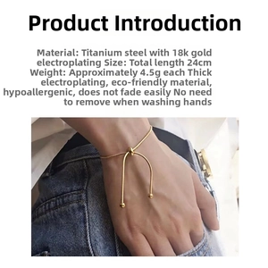 Detail of 18k gold plated snake chain bracelet featuring adjustable sliding metal bead