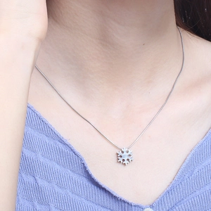 Silver snowflake pendant necklace on a model showing sweet minimalist style for women
