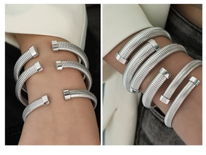 Close-up of silver vertical striped open cuff bracelet with industrial spiral texture