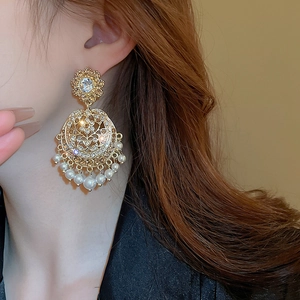 Macro shot of vintage palace style earrings with pearls and crystals on a model