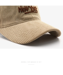 Detailed close-up of corduroy fabric texture and NEW YORK embroidery on the beige cap