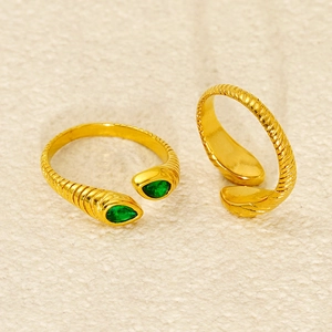 Adjustable gold ring set with pear-cut green stones and textured stainless steel band
