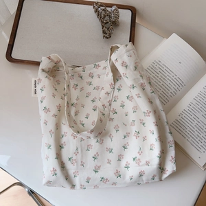 Detail of floral cotton handbag with small red flowers and a 'simple wish' fabric label