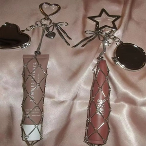 Silver woven lipstick holder keychain with heart-shaped mirror and metal mesh net