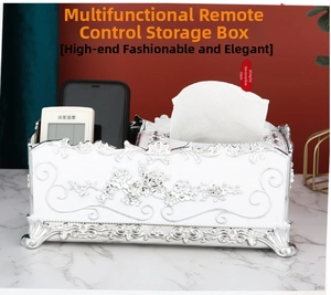 Detail of silver floral embossed tissue box with dual storage compartments for remotes