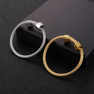 Minimalist C-shaped cable bangles in silver and gold with hexagonal geometric ends