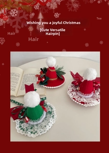 Detail view of handmade Christmas hair clips with bows and pom-poms on a cream table