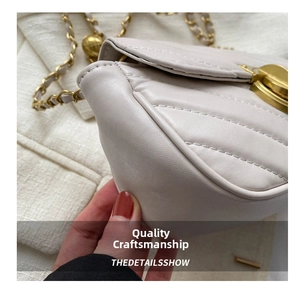 Detailed macro view of quilted cream leather bag with precise stitching and gold chain