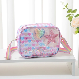 Detail of glitter heart bag featuring liquid sequin pocket and rainbow strap