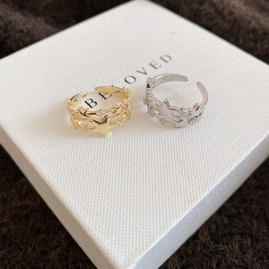 Detail of three-layer star open rings in gold and silver set with sparkling zircon