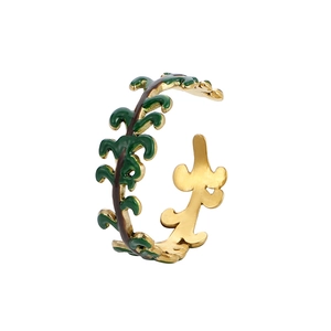 Gold-plated vine leaf open ring with green enamel accents on a clean white background