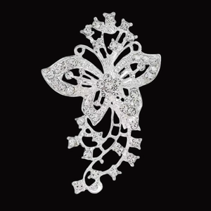 Macro detail of silver alloy butterfly brooch featuring sparkling rhinestone pavé setting