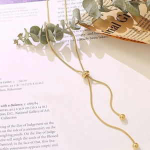 Close-up of adjustable 18k gold plated snake chain necklace with slider bead detail