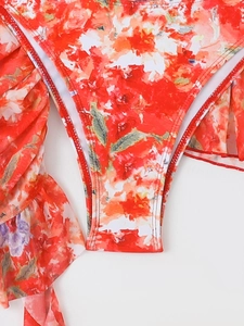 Macro detail of red floral print swimwear fabric with ruffle edge and quality stitching