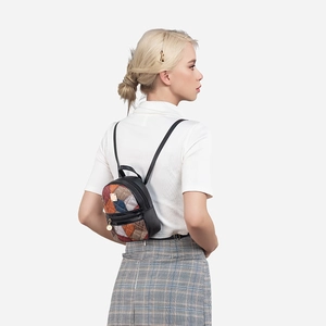 Chic women's patchwork plaid backpack with black straps shown on a model model for style