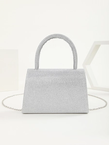 Detail of silver sequin evening bag featuring glitter texture and metal chain strap