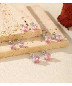 Macro detail of multiple pink round cut gemstone stud earrings in four-prong silver settings