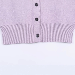 Lavender knit cardigan featuring ribbed hem detail and elegant black contrast buttons