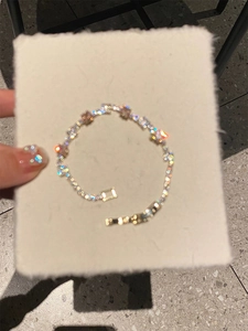 Detailed close-up of a silver zircon chain bracelet with delicate star-shaped links