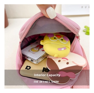 Interior view showing capacity for small items like earphones and mirror in pink bag