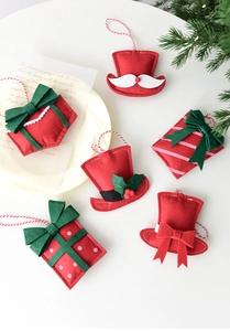 Close-up of assorted felt Christmas ornaments including Santa hats and gift boxes