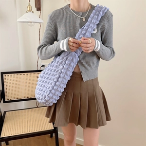Detail of light blue bubble texture tote bag with quilted fabric and wide shoulder strap