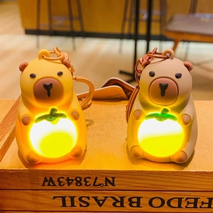 Luminous Capybara plush keychain holding a glowing orange, cute bag pendant and car accessory