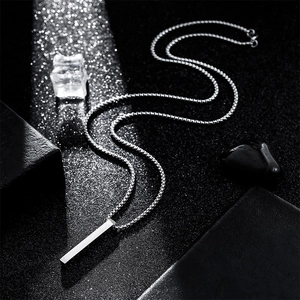 Minimalist silver stainless steel pillar pendant necklace for men with bead chain on black background