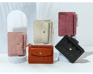 Detail of multi-colored crocodile embossed PU leather wallets with zipper and snap closure