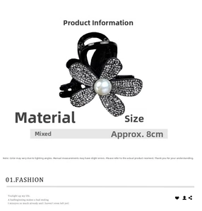 Close-up of black hair claw clip featuring sparkling diamond flowers and a central white pearl