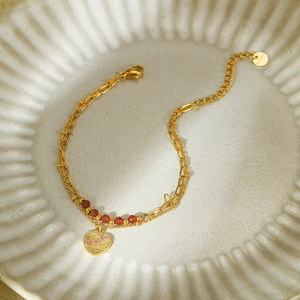 Golden double-layer stainless steel bracelet with red beads and sparkling heart pendant