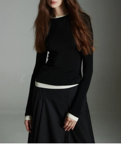 Close-up of contrast trim details on wool knit top with faux two-piece collar