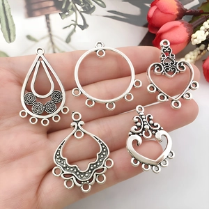 Set of five vintage alloy jewelry pendants in silver including heart and teardrop shapes