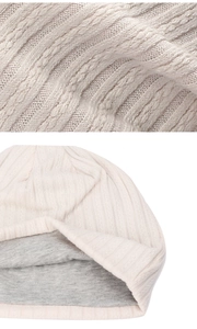 Detail showing the double-layer knit structure with cream ribbed fabric and grey lining
